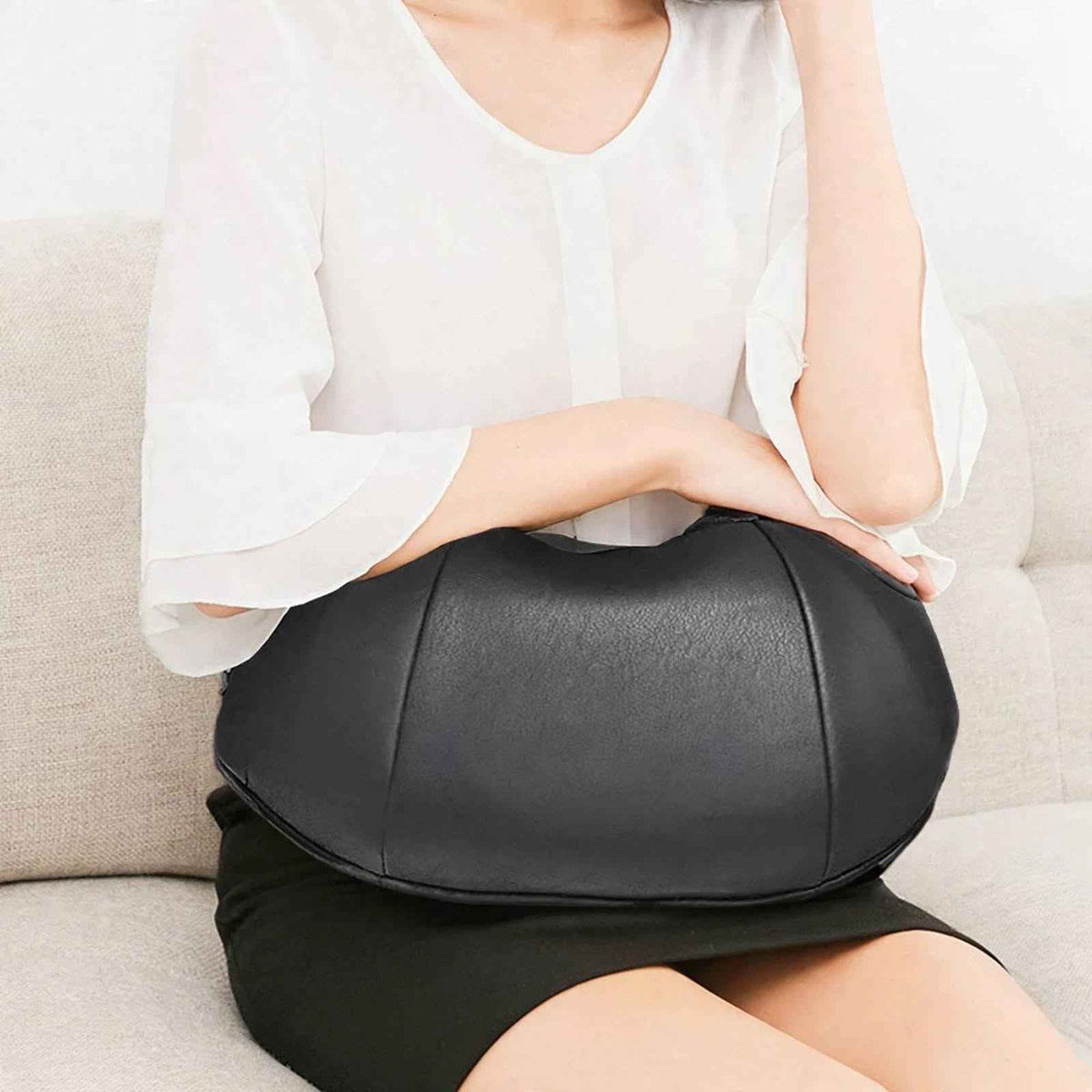 Shiatsu neck and shoulder massager resting on the lap