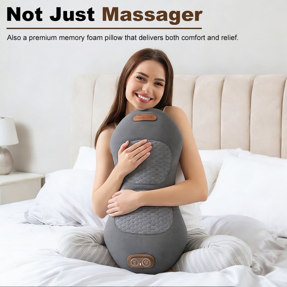 Woman sitting on a bed hugging the dark gray memory foam back massager pillow