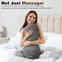 Woman sitting on a bed hugging the dark gray memory foam back massager pillow